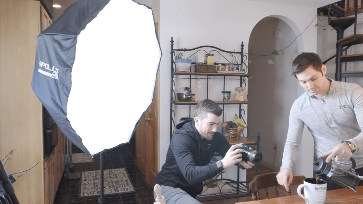 Anthony Gallo and Paul Xavier working on a filming shot with a lighting setup in the background.